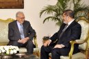 In this image released by the Egyptian Presidency, U.N.-Arab League envoy, Lakhdar Brahimi, left, meets Egyptian President Mohammed Morsi, in Cairo, Egypt, Monday, Sept. 10, 2012. Brahimi, who is tasked with brokering a diplomatic solution to the Syrian conflict, replaced former U.N. Secretary-General Kofi Annan, who stepped down in August in frustration after his six-point peace plan collapsed. Brahimi, said he will travel to Syria this week to meet with regime officials as well as representatives of civil society. (AP Photo/Egyptian Presidency)