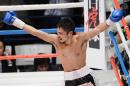 Japanese challenger Kohei Kono celebrates after knocking out champion Tepparith Kokietgim of Thailand in the fourth round of their WBA super flyweight title boxing bout in Tokyo on December 31, 2012