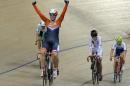 Kirsten Wild of the Netherlands celebrates after winning the final of the Women's Scratch 10 km race at the Track Cycling World Championships in Saint-Quentin-en-Yvelines, outside Paris, France, Saturday, Feb. 21, 2015. (AP Photo/Christophe Ena)