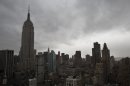 Storm clouds loom over the Empire State Building and Manhattan skyline, Monday, Oct. 29, 2012, in New York. Hurricane Sandy continued on its path Monday, forcing the shutdown of mass transit, schools and financial markets, sending coastal residents fleeing, and threatening a dangerous mix of high winds and soaking rain. (AP Photo/ John Minchillo)