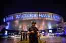 Turkish police on duty at Ataturk airport after a gun and suicide bomb assault that killed 45 people