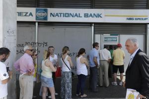 People line up to use ATM machines of a bank after &hellip;