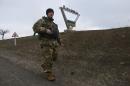 A Ukrainian serviceman patrols on the outskirts of the village of Pavlopil, in the Donetsk region