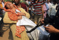 A Bangladeshi woman cries as she claims the body of her relative killed in a fire at a garment factory outside Dhaka, Bangladesh, Sunday Nov. 25, 2012. At least 112 people were killed in a late Saturday night fire that raced through the   multi-story
 garment factory just outside of Bangladesh's capital, an official said Sunday.(AP Photo/ Jibon Amir)