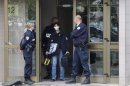 A police crime scene technician leaves a building in the Esplanade suburb of Strasbourg