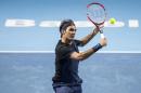 Switzerland's Roger Federer returns a ball to Belgium's David Goffin during their quarter final match of the Swiss Indoors tennis tournament at the St. Jakobshalle in Basel, Switzerland, Friday, Oct. 30, 2015. (Alexandra Wey/Keystone via AP)