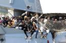 Migrants stand on board of Italian Navy ship Chimera before to be disembarked in southern harbour of Salerno