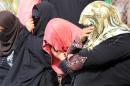 Iraqi female detainees hide their faces after being freed on February 28, 2013 in the Iraqi capital Baghdad