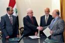 A photograph made available by the office of the Iraqi President on August 11, 2014, shows Iraqi President Fuad Masum (2nd L) shaking hands with deputy parliamentary speaker Haidar al-Abadi (R) after he was tasked with forming a government