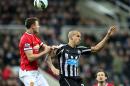 Manchester United's Jonny Evans, left, vies for the ball with Newcastle United's Gabriel Obertan, right, during their English Premier League soccer match between Newcastle United and Manchester United at St James' Park, Newcastle, England, Wednesday, March, 4, 2015. (AP Photo/Scott Heppell)
