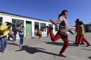 Students play a rope-skipping game during a break at Pengying School on the outskirts of Beijing