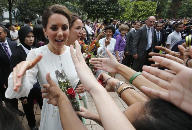 Catherine, Britain's Duchess of Cambridge, shakes hands with well-wishers at KLCC Park in Kuala Lumpur