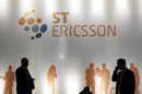 People walk past an ST-Ericsson stand at the Mobile World Congress in Barcelona