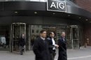 People pass the AIG building, in New York, Tuesday, Jan. 8, 2013. American International Group Inc. said Tuesday its board of directors will weigh whether to take part in a shareholder lawsuit against the U.S. over the government's $182 billion bailout of the insurer. (AP Photo/Richard Drew)