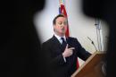 British Prime Minister David Cameron gives a press conference in Brussels on December 20, 2013