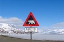 Sign warns residents of arctic Svalbard islands in Norway of danger from roaming polar bears