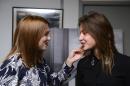 The two main actresses in the French film 'La Vie d'Adele' (known in English as 'Blue is the Warmest Color'), Lea Seydoux (L) and Adele Exarchopoulos (R) pose for photographs on February 4, 2014, in Paris