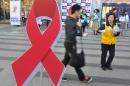 A South Korean Red Cross official hands out information leaflets during World AIDS Day in Seoul, on November 30, 2009