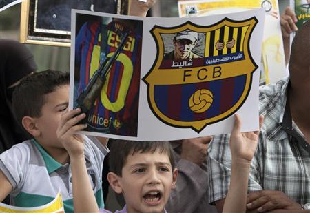 Palestinians protest against the presence of former Israeli captive soldier Shalit at the upcoming Spanish first division soccer match between Barcelona and Real Madrid, during a demonstration in Jerusalem