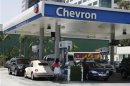 Motorists are shown at gas pumps at a Chevron gasoline station in Burbank