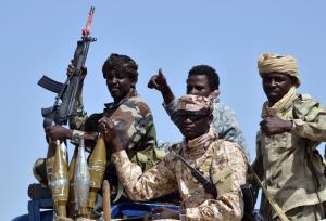 Chadian army soldiers sit in theback of a military …