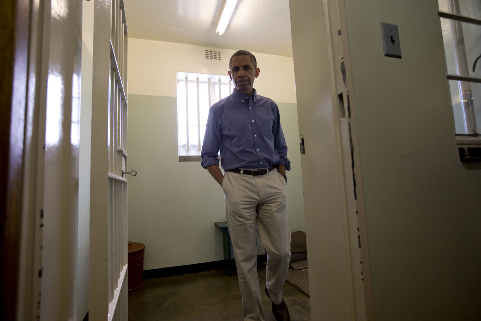 RETRANSMISSION TO CORRECT SPELLING OF PRESIDENT'S FIRST NAME - U.S. President Barack Obama walks from Section B, prison cell No. 5, on Robben Island, South Africa, Sunday, June 30, 2013. This was former South African president Nelson Mandela's cell, where he spent 18-years of his 27-year prison term on the island locked up by the former apartheid government. (AP Photo/Carolyn Kaster)