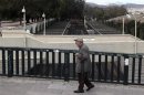 A man walks over an empty train station in Athens during a strike