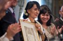 Myanmar pro-democracy leader Aung San Suu Kyi poses after receiving an honorary citizen award