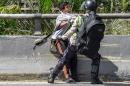 Riot police arrest a demonstrator during a march of opposers in Caracas, on September 1, 2016