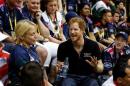 Britain's Prince Harry jokes as he sits in the stands to watch sitting volleyball during the Invictus Games in Orlando, Florida
