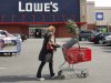 FILE - In this  Feb 21, 2012, file photo, a customer shops at Lowe's in New York. Lowe's said Monday, Nov. 19, 2012, its third-quarter net income surged 76 percent, helped by fewer charges and higher revenue. Its shares rose 5 percent in early premarket trading Monday. (AP Photo/Mark Lennihan, File)
