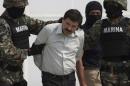 In this Saturday, Feb. 22, 2014 photo, Joaquin "El Chapo" Guzman is escorted to a helicopter in handcuffs by Mexican navy marines at a navy hanger in Mexico City, Mexico. Guzman, the head of Mexico's Sinaloa Cartel, was captured overnight in the beach resort town of Mazatlan. (AP Photo/Eduardo Verdugo)