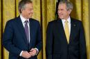 US President George W. Bush (R) smiles alongside former British Prime Minister Tony Blair (L) at the White House on January 13, 2009