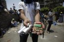 A member of the Muslim Brotherhood and supporter of Mursi displays spent ammunition after clashes with army in front of Republication Guard headquarters in Nasr City