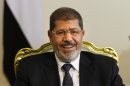 Egypt's newly elected President Mohammed Morsi smiles as he meets with Bulgarian foreign minister, not pictured, in Cairo, Egypt, Tuesday, July 31, 2012. (AP Photo/Amr Nabil)