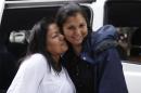 Jacqueline Vasquez Sanchez, left, embraces her sister Lorena Sanchez, right, before a press conference in Bogota, Colombia, Thursday, Feb. 25, 2016. The reunited sisters were separated more than 30 years ago, when on November 13, 1985, the Nevado del Ruiz volcano erupted triggering a deluge of mud and debris that buried the town of Armero, killing more than 25,000 people in and around the town. (AP Photo/Fernando Vergara)