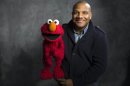 FILE - This Jan. 24, 2011 photo shows "Sesame Street" muppet Elmo and puppeteer Kevin Flash poses for a portrait in the Fender Music Lodge during the 2011 Sundance Film Festival to promote the film "Being Elmo" in Park City, Utah. Clash has taken a leave of absence from the popular kids' show following allegations that he had a relationship with a 16-year-old boy. Sesame Workshop says Kevin Clash denies the charges, which were first made in June by the alleged partner, who by then was 23. In a statement issued Monday, Nov. 12, 2012, Sesame Workshop says its investigation found the allegation of underage conduct to be unsubstantiated. (AP Photo/Victoria Will, file)
