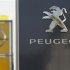 The logos of German General Motors daughter Opel and French car maker Peugeot are seen at a Opel and Peugeot dealership in Leverkusen