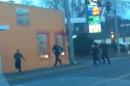 In this still frame taken from a cell phone video provided by Dario Infante and taken on Feb. 10, 2015, Antonio Zambrano-Montes, left, turns to face police officers while running from them in Pasco, Wash. Moments later, Zambrano-Montes was shot and killed. Pasco police said he threw multiple rocks, hitting two officers, and refused to put down other stones. (AP Photo/Dario Infante)