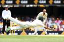 10ThingstoSeeSports - Replacement fielder Marnus Labuschagne is airborne as he dives to take a catch to dismiss India's Varun Aaron during play on day two of the second cricket test in Brisbane, Australia, Thursday, Dec. 18, 2014. (AP Photo/Tertius Pickard, File)