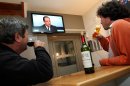 French people watch a live broadcast television debate with French President Francois Hollande, in a bar in a village of La Bastide Clairence, southwestern France, Thursday, March 28, 2013. (AP Photo/Bob Edme)