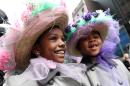 Sasha Bryant, left, and her sister India Bryant walk in the Easter Parade along New York's Fifth Avenue on Sunday, April 5, 2015. (AP Photo/Tina Fineberg)