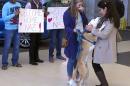 Nazanin Zinouri, 29, is greeted at the Greenville-Spartanburg International Airport in Greer, S.C., with kisses from her dog Dexter and well-wishers holding signs reading "Welcome Home" on Monday, Feb. 6, 2017. Zinouri, an Iranian engineer and Clemson University graduate, had been unable to return to the United States because of the executive order President Donald Trump signed that limited travel to the U.S. from seven Muslim-majority countries. (AP Photo/Alex Sanz)