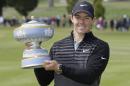 Rory McIlroy, of Northern Ireland, poses with his trophy on the 16th green of TPC Harding Park after winning the Match Play Championship golf tournament Sunday, May 3, 2015, in San Francisco. (AP Photo/Eric Risberg)