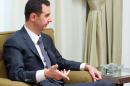 A handout picture released by the Syrian Arab News Agency (SANA) shows Syrian President Bashar al-Assad giving an interview to a local newspaper in Damascus on July 02, 2013