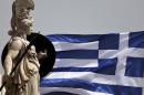A Greek national flag flutters next to a statue of ancient Greek goddess Athena, in Athens