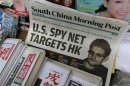 A copy of the South China Morning Post newspaper, carrying the latest interview of Snowden, is displayed on a newspaper stand along with local Chinese newspapers in Hong Kong