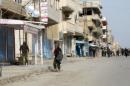 Syrian security forces are seen during a protest in Qamishli on March 12, 2012