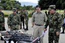 Colombia's Defense Minister Pinzon and Gen. Navas review seized weapons of FARC guerrillas at an army base in Tame