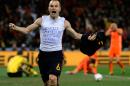 FILE - In this July 11, 2010 file photo, Spain's Andres Iniesta celebrates after scoring a goal, with the words "Dani Jarque, always with us", written on his undershirt, during the World Cup final soccer match between the Netherlands and Spain, at Soccer City in Johannesburg, South Africa. On this day: Four minutes from the end of extra time, Iniesta scores to win the World Cup for Spain for the first time. (AP Photo/Martin Meissner, File)